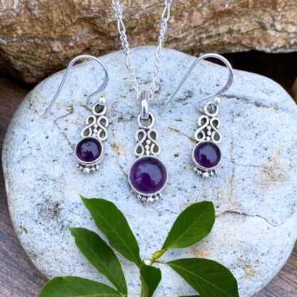 an image of a dainty round Sterling Silver and Amethyst Infinity Jewelry Set with a double infinity symbol above each gemstone