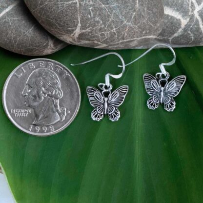 an image of a pair of Oxidized Sterling Silver Butterfly Dangle Earrings next to a quarter