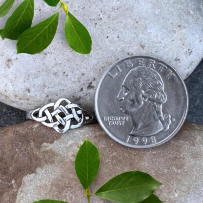 an image of a Sterling Silver Celtic Knot Ring next to a quarter