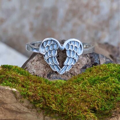 an image of a sterling silver ring of two angel wings forming a heart