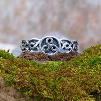 an image of a sterling silver ring with a Celtic Triskele symbol in a circle in the center and a Celtic knot design on each side