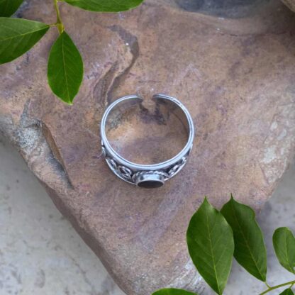 an image of an overhead view of an image of a side view of a Sterling Silver Bali Toe Ring with a round black agate gemstone in the center