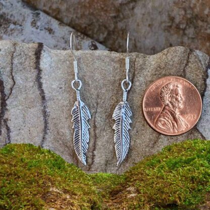 an image of a pair of Sterling Silver Feather Dangle Earrings next to a penny