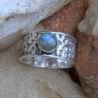 an image of a wide sterling silver band style ring with an abstract design and a round labradorite gemstone in the center