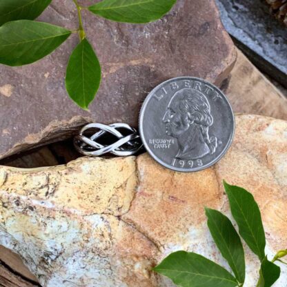 an image of a Simple Celtic Weave Sterling Silver Ring next to a quarter