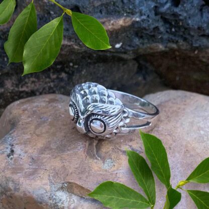 an image of a side view of a sterling silver ring with an owl head