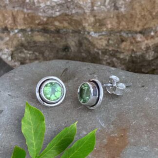 An image of a pair of 8mm x 8mm Classic Round Faceted Peridot and Sterling Silver Stud Earrings