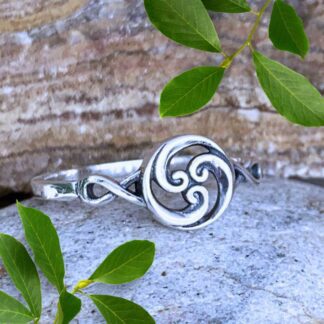 an image of a sterling silver ring with an open circle design on top with three silver ocean wave swirls circling around.