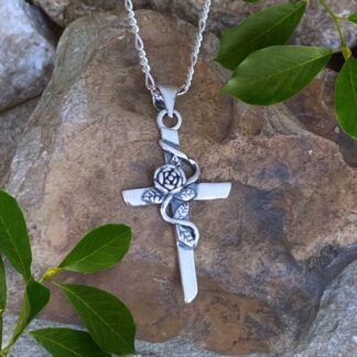 an image of a Sterling Silver Cross Pendant with Rose and leaves at the center and oxidation behind the rose and leaves with a 1.18 inch drop