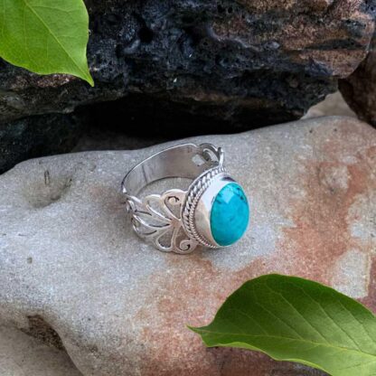 a side view image of an oval Turquoise ring in sterling silver with elegant filigree work on the sides