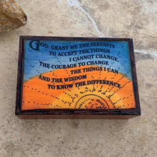 an image of a blue and yellow sky and sun background box with the Serenity Prayer carved on the front. Dimensions are 5 in. x 3-5/8 in. x 1 and a half inches