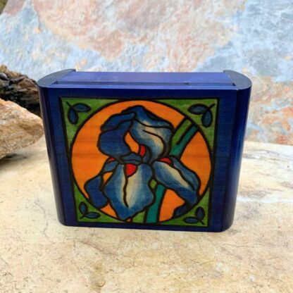 an image of a Handcrafted Secret Locking Iris Box that is blue with an iris flower in a circle on the front and measures 6.00 x 4.68 x 2.50 inches