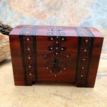 an image of a Pirate Trunk style Keepsake Box handcrafted of wood in a dark burgundy color with black trim. Made in Poland. Dimensions are 5.50 x 3.50 x 3.50 inches. This is a front view