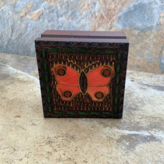 an image of a 3.125 inch square handcrafted brown wooden box with an reddish orange butterfly carved on the top