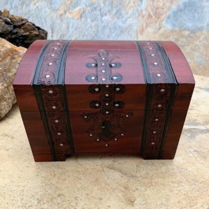 an image of a Pirate Trunk style Keepsake Box handcrafted of wood in a dark burgundy color with black trim. Made in Poland. Dimensions are 5.50 x 3.50 x 3.50 inches