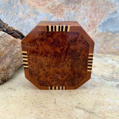 an image of an Octagon Shaped Moroccan Thuya and Lemon Wood Box. The top has beautiful burl wood and four sides have a striped inlay pattern of yellow lemon wood with lemon wood that has been dyed black. The dimensions are 4.5 x 4.5 x 2 inches.