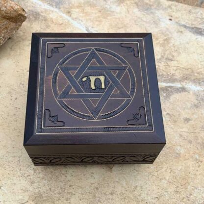 An image of a dark brown handcrafted wood box with a Star of David on the top and the word Chai in the center of the star. Dimensions are 4.75 x 4.75 x 3.00 inches