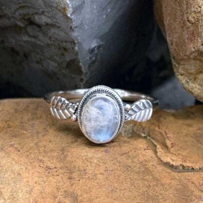 an oval rainbow moonstone gemstone Ring with a sterling silver leaf on each side