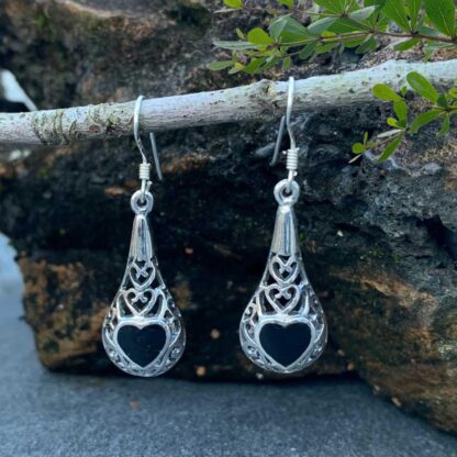 an image of a dangling pair of sterling silver filigree earrings with a black onyx heart on each earrings