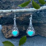 pair of sterling silver filigree earrings with a Turquoise heart on each earrings