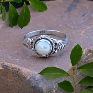 an image of a dainty Round Pearl and Sterling Silver Ring with a silver leaf on each side of the pearl