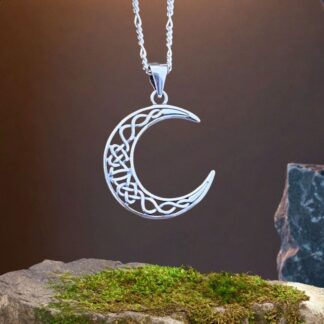 an image of a crescent moon pendant with an open Celtic knot design in the moon.