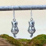 an image of a pair of Sterling Silver Filigree Cat Earrings with their backs facing out and tail hanging down.