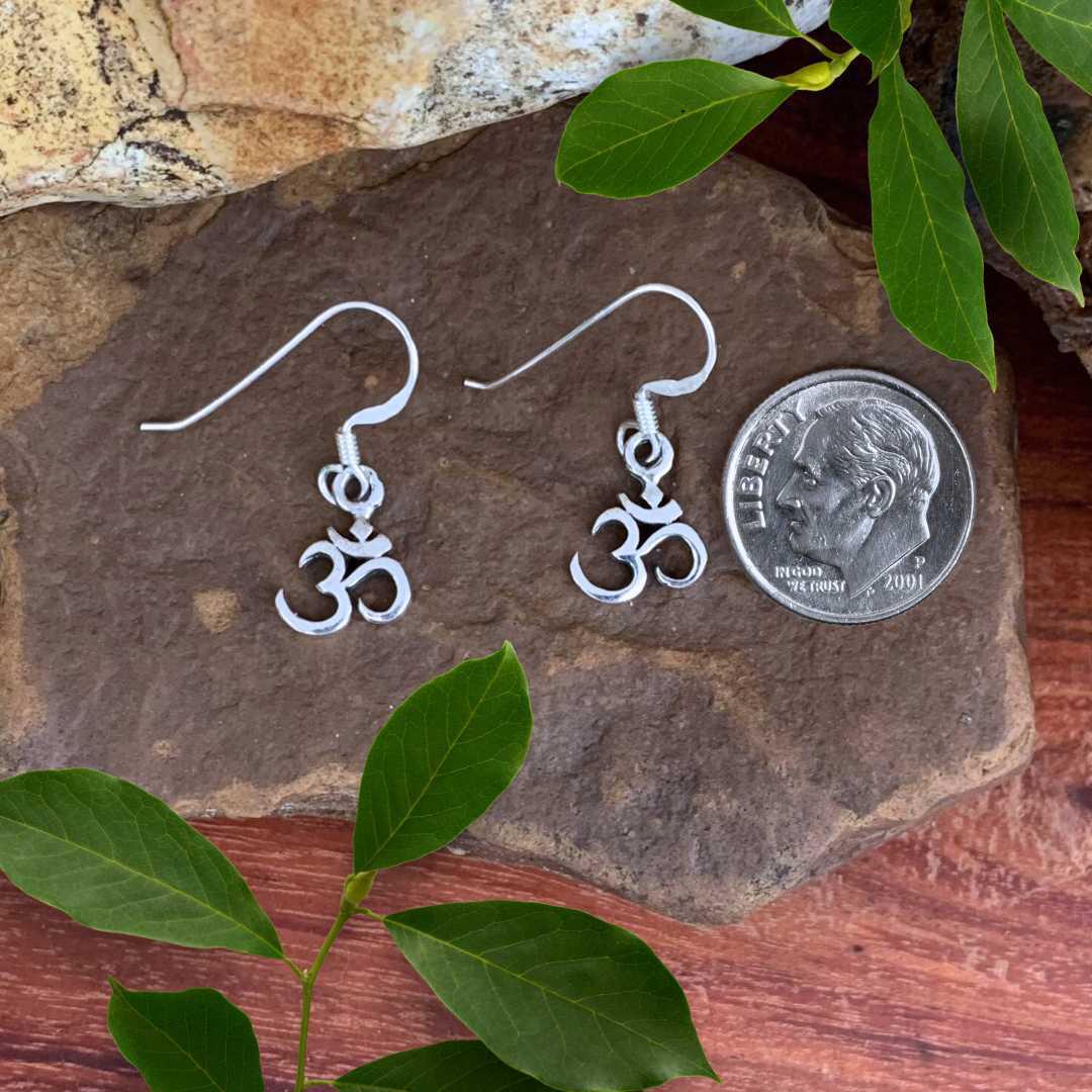 an image of aPetite Sterling Silver Om Dangle Earrings next to a dime
