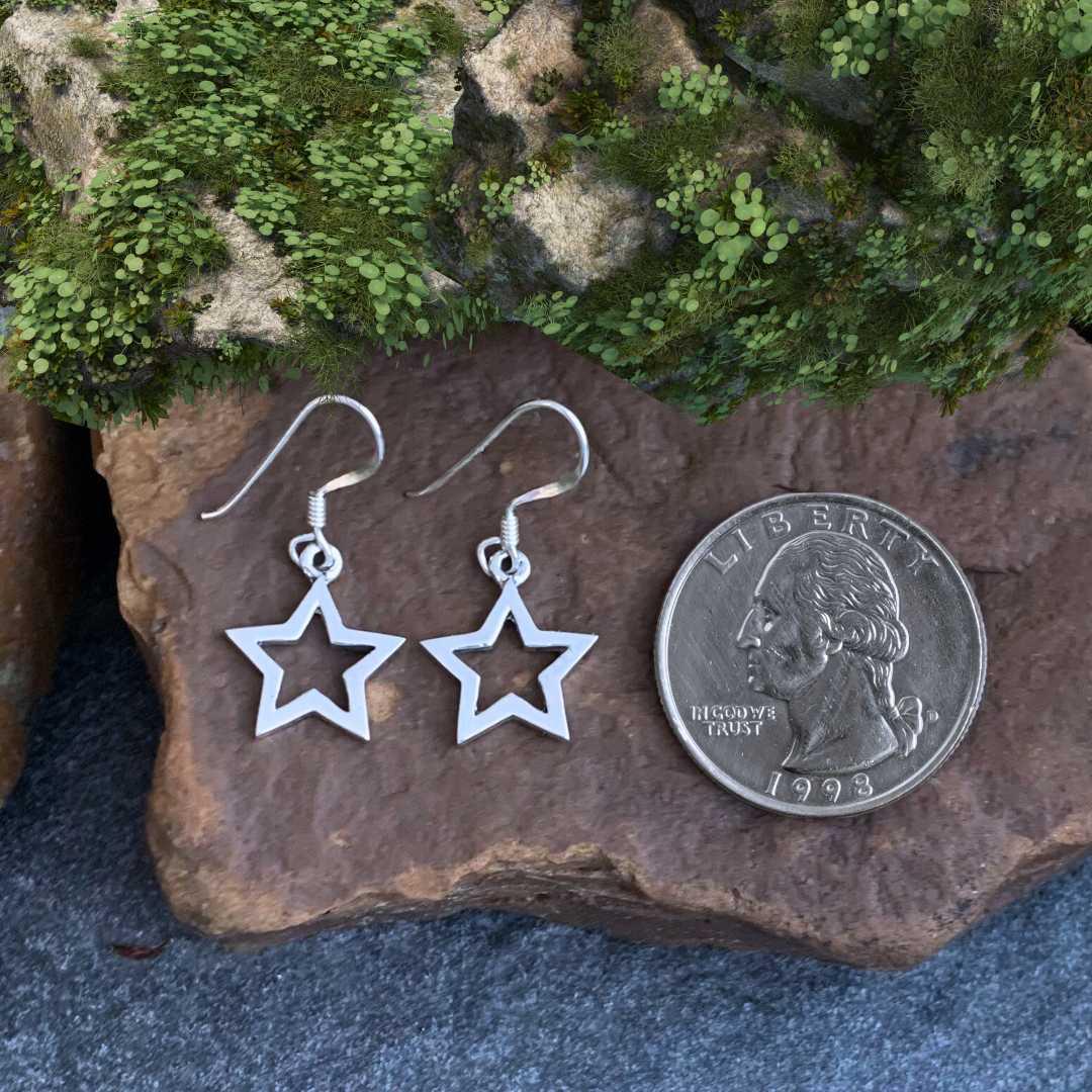 an image of a Sterling Silver Open Star Dangle Earrings next to a quarter