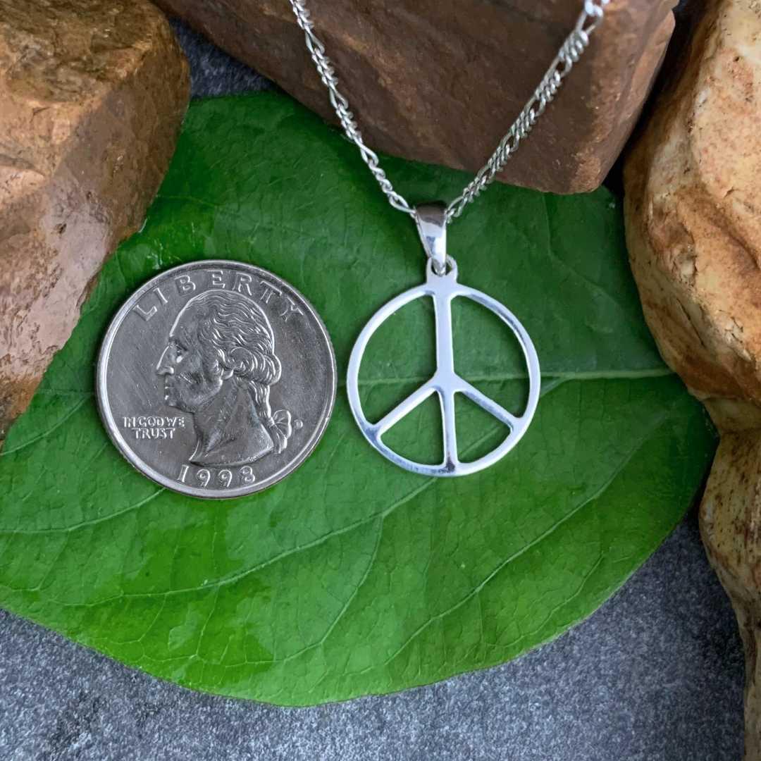 an image of a Polished Sterling Silver Peace Sign Pendant next to a quarter
