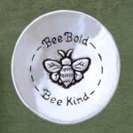 an image of a Pewter Bee Lovers Charm Bowl that has a bee in the center and says Bee Bold, Bee Kind and is 3 x 3 inches in diameter
