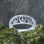 an image of a sterling silver ring with three open peace signs