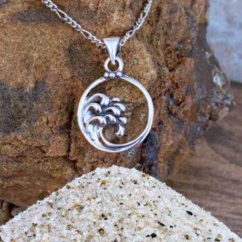 an image of an open circle with ocean waves on the left side going into the center of this sterling silver pendant