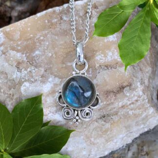 An image of a dainty round labradorite gemstone pendant set in sterling silver with a swirling design at the bottom