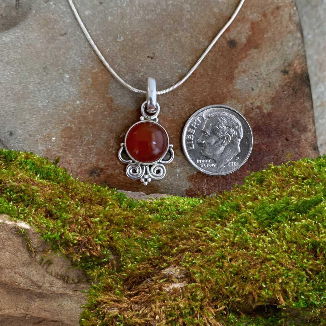 an image of a Pretty Carnelian and Sterling Silver Swirl Pendant with a dime
