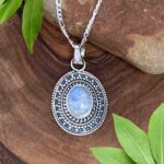 an image of an oval Rainbow Moonstone and Sterling Silver Ornate Pendant