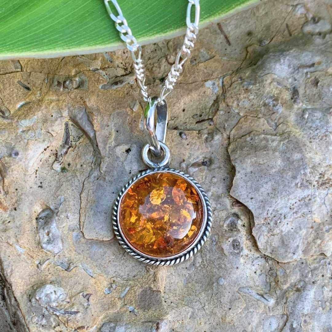 An image of a Round Amber and Sterling Silver Pendant that is .59 inches in diameter