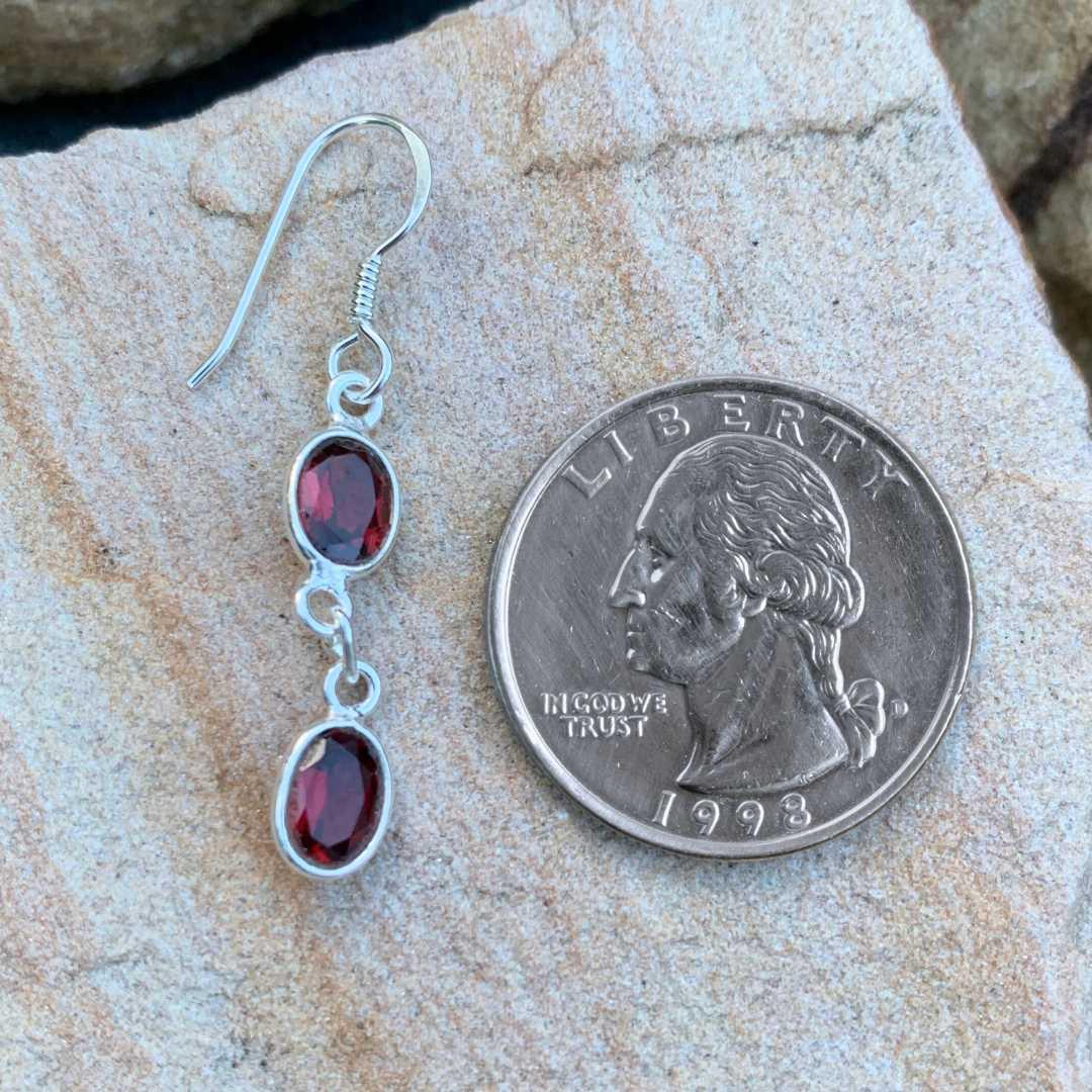 an image of a Double Faceted Garnet and Sterling Silver Earring next to a quarter
