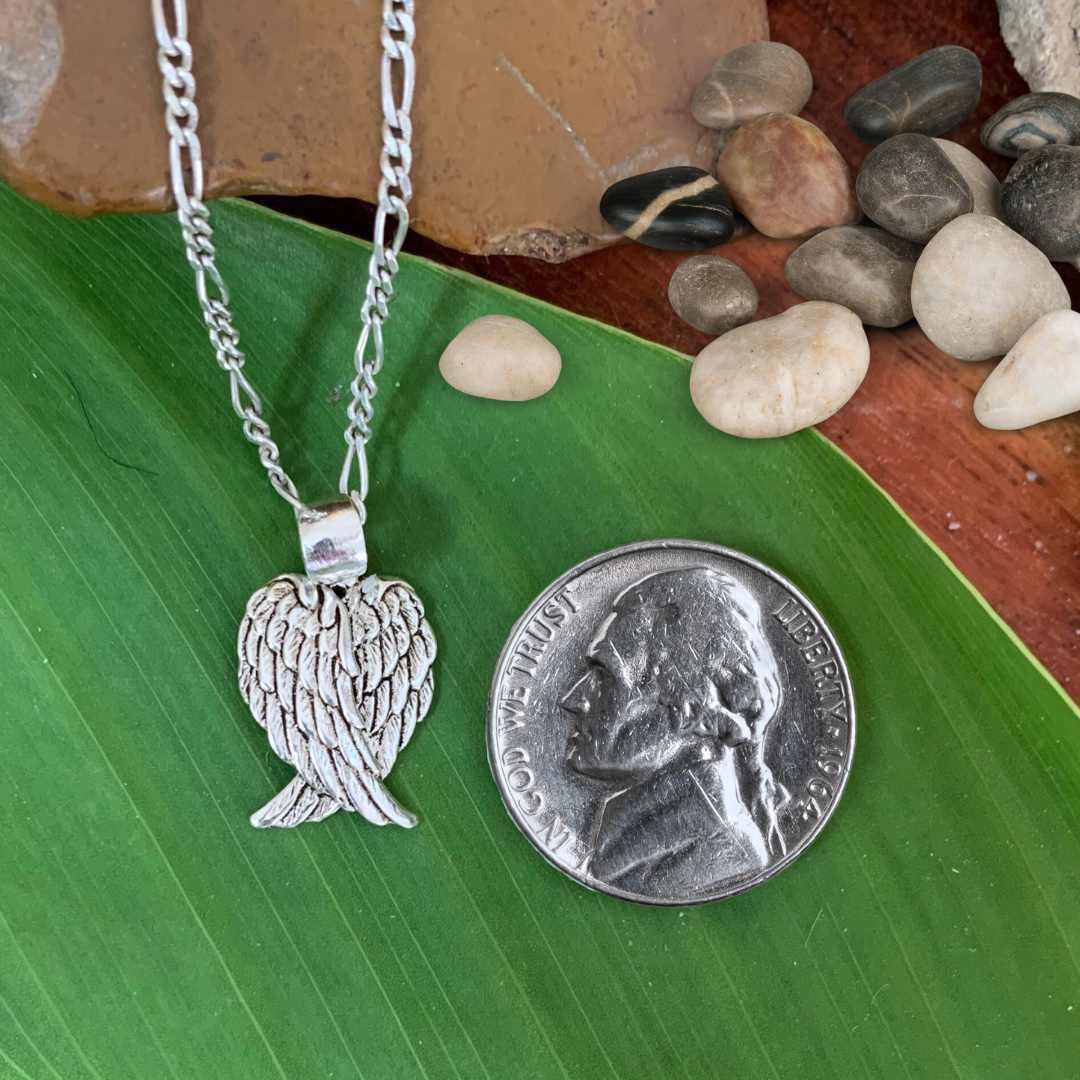 an image of a Sterling Silver Heart Shaped Angel Wings Pendant next to a quarter