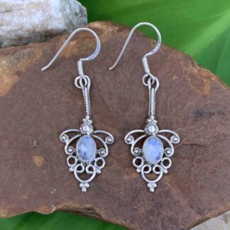 an image of a pair of Sterling Silver and Rainbow Moonstone Feminine Earrings with a 1.9 inch total drop and a lacy sterling filigree look around an oval rainbow moonstone.