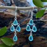 an image of a pair of Blue Topaz and Sterling Silver Chandelier Earrings with 4 teardrop shaped faceted blue topaz gemstones