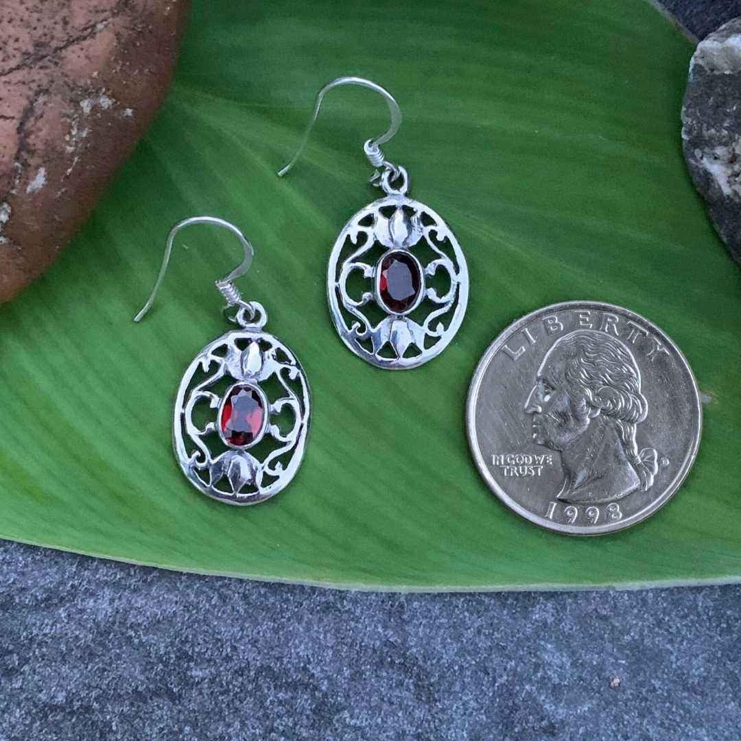 an image of a pair of Oval Filigree Garnet and Sterling Silver Earrings next to a quarter