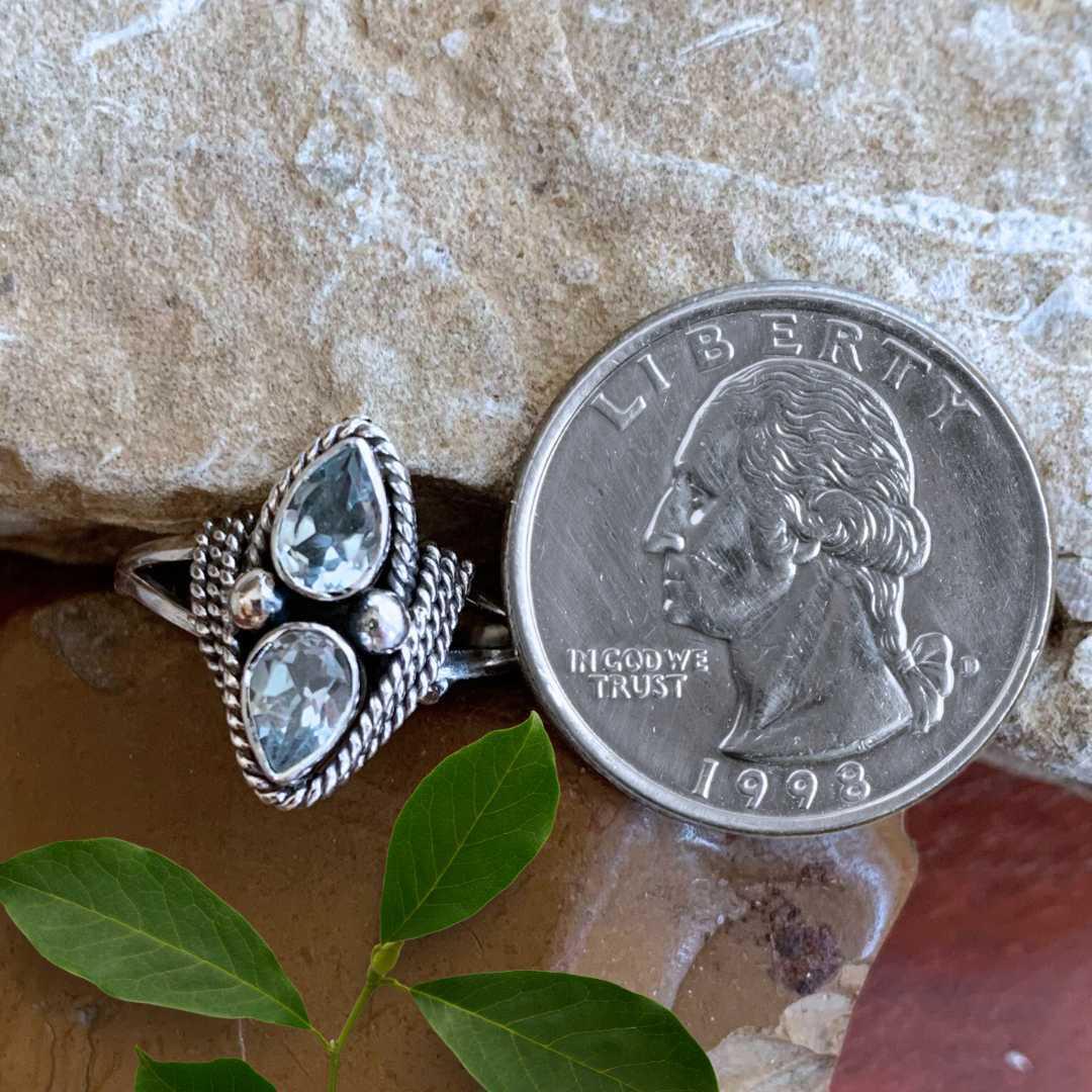 an image of a Double Faceted Blue Topaz and Sterling Silver Ring next to a quarter