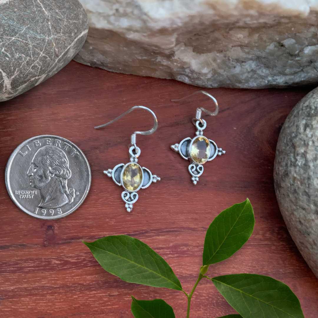 an image of a pair of Ornate Sterling Silver and Oval Citrine Earrings next to a quarter
