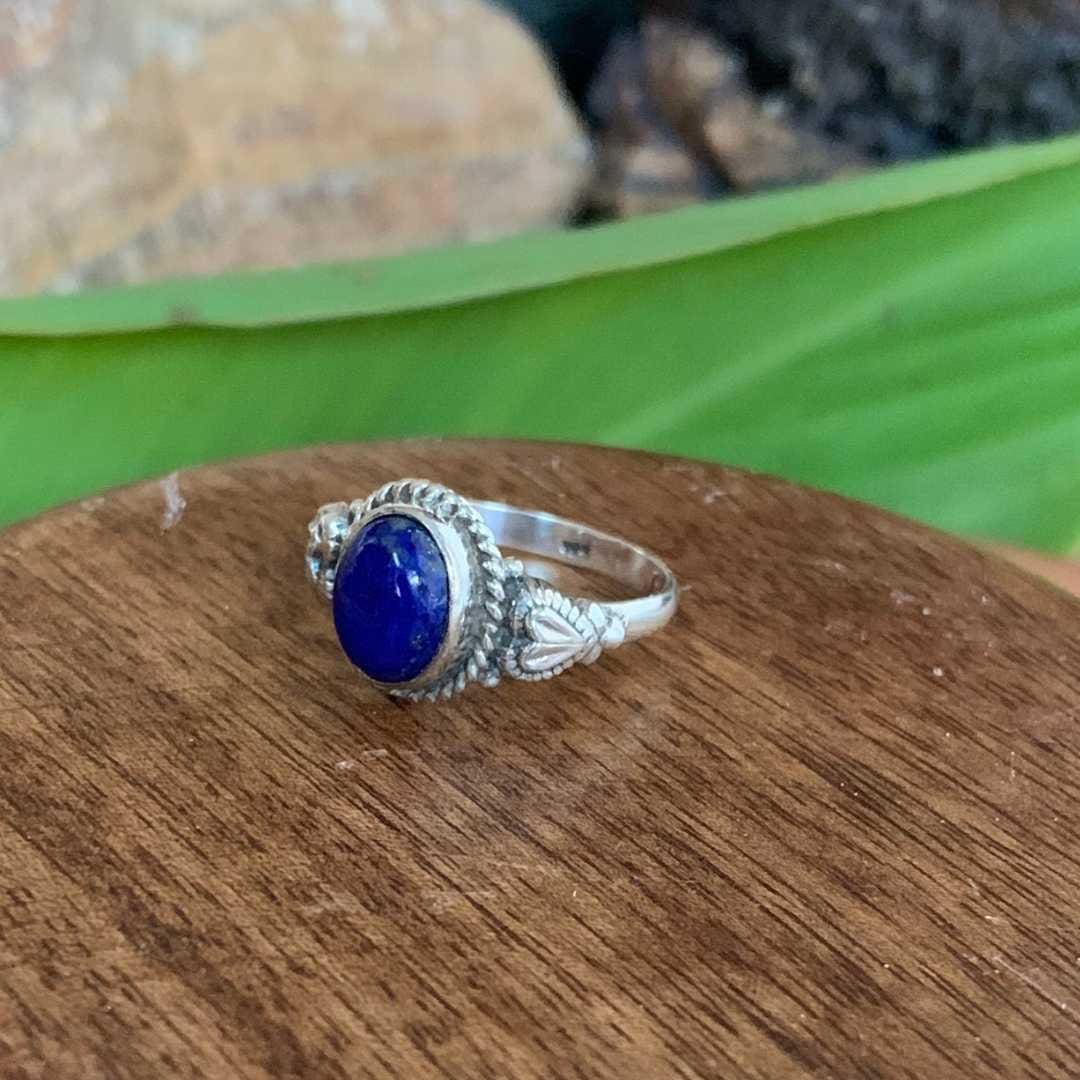 an side view image of an Oval Lapis Lazuli and Sterling Silver Ring With a heart on each side