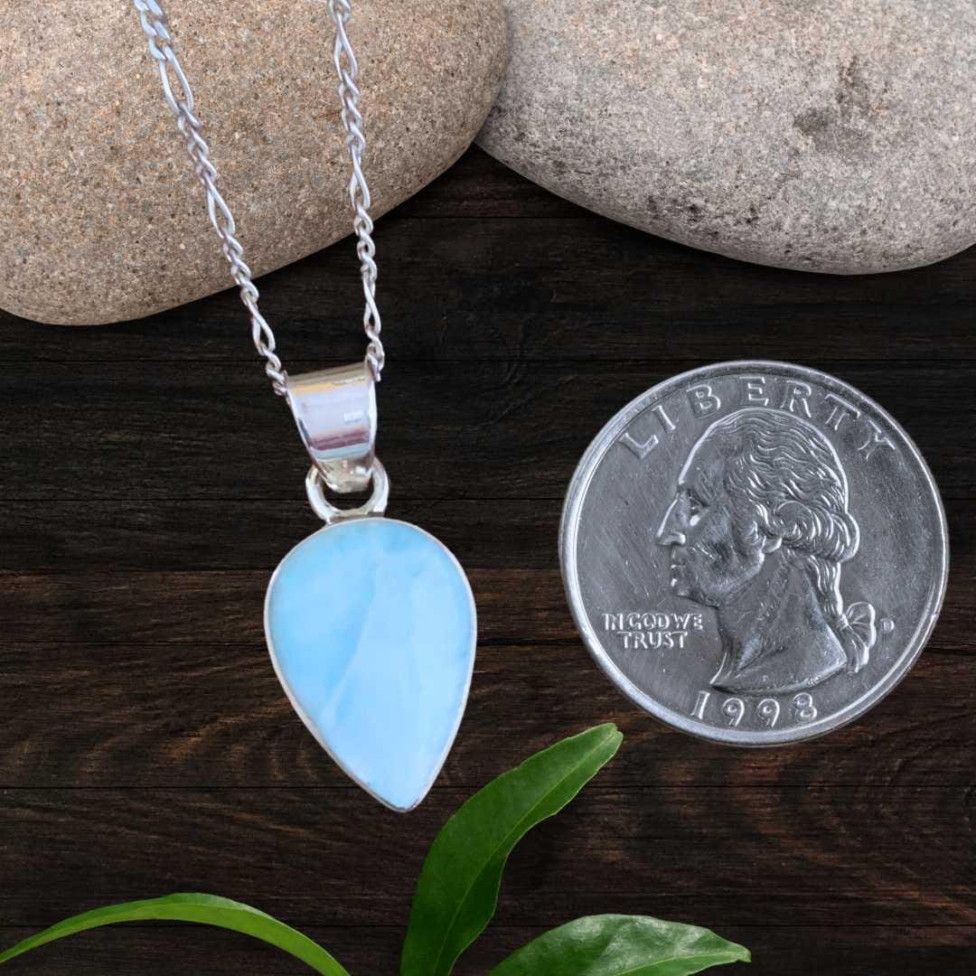an image of a Dainty Teardrop Larimar and Sterling Silver Pendant next to a quarter
