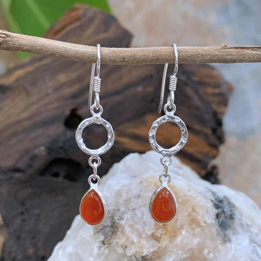An image of a pair of Hammered Sterling Circle with Carnelian Teardrop Earrings