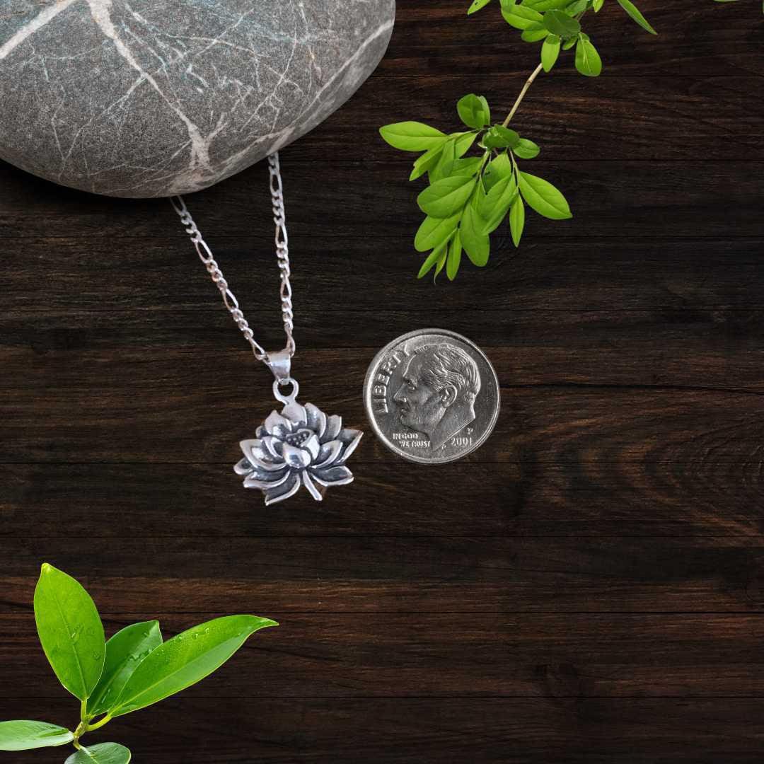 an image of a Detailed Sterling Silver Blooming Lotus Pendant next to a dime