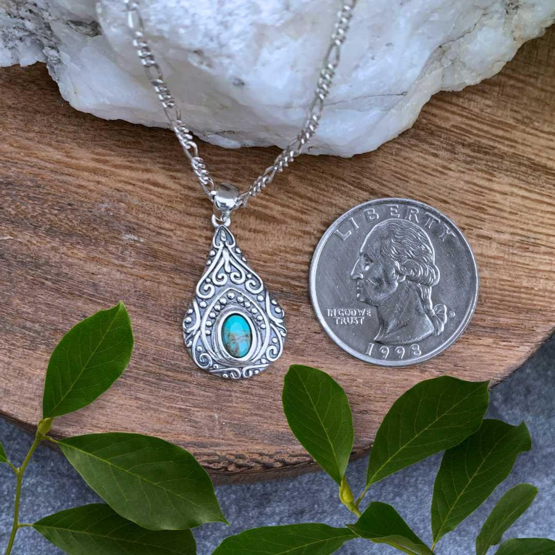 an image of a Pear Shaped Vintage Style Turquoise Pendant next to a quarter