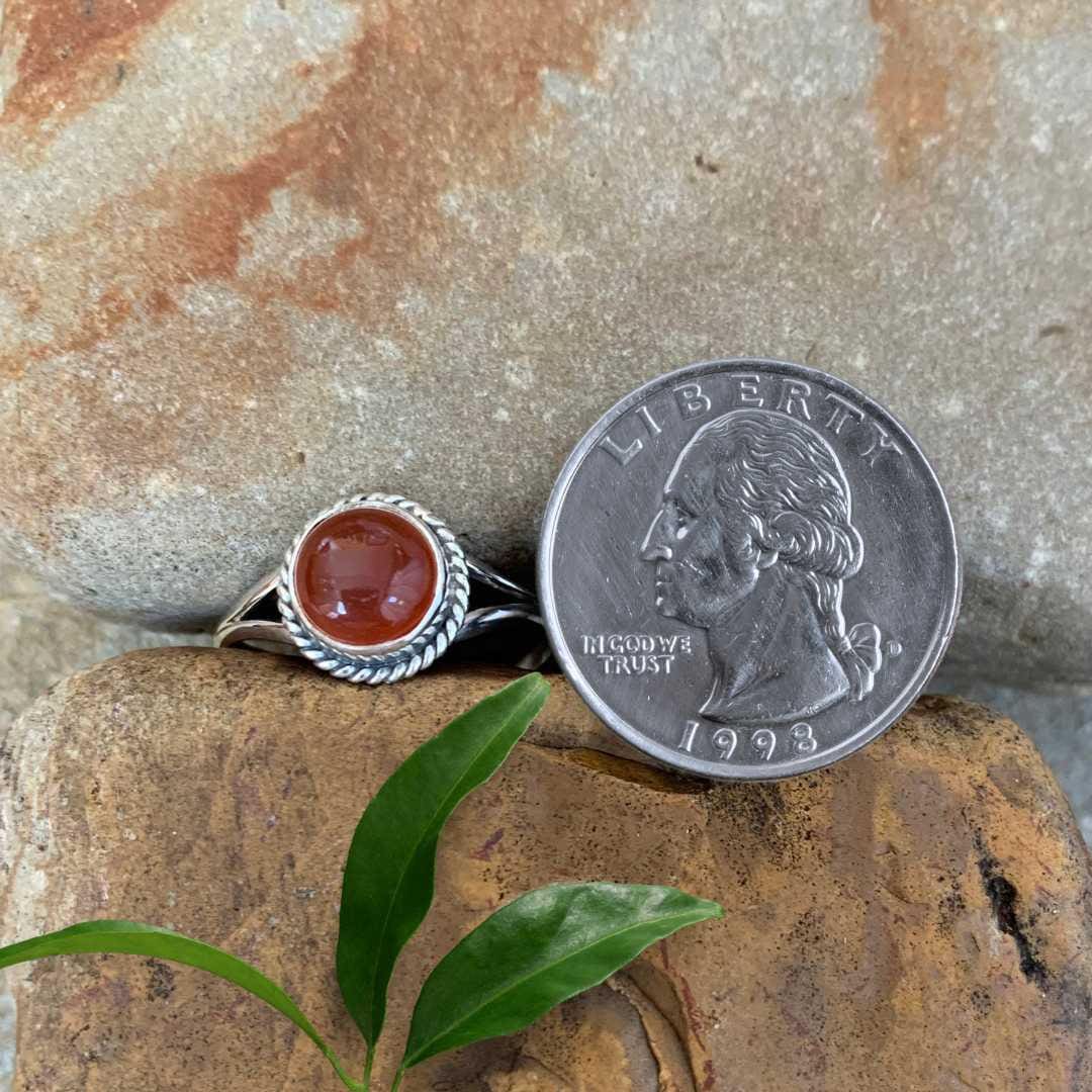 an image of a Round Carnelian and Sterling Silver Ring next to a quarter